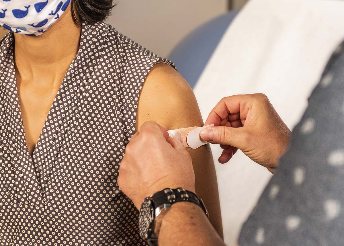 Person receiving a bandage after a COVID-19 vaccine