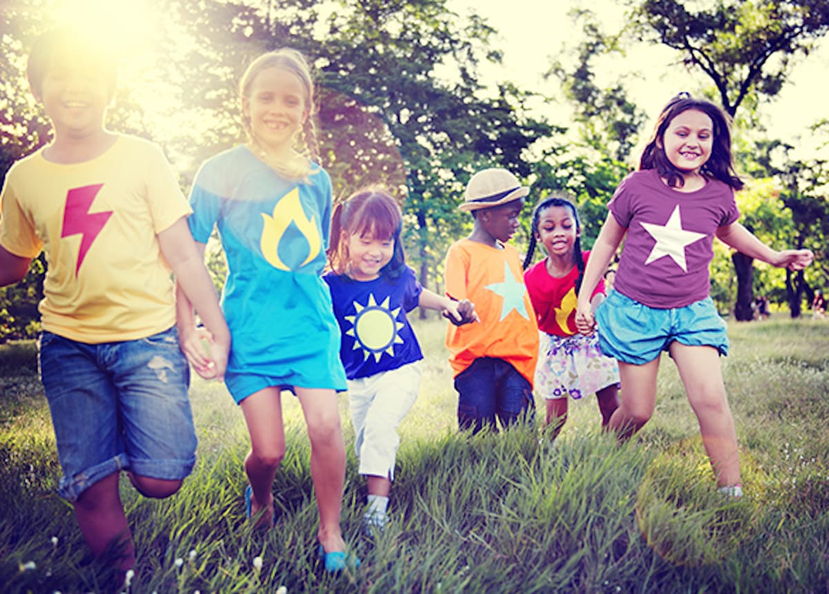 Kids running outdoors holding hands