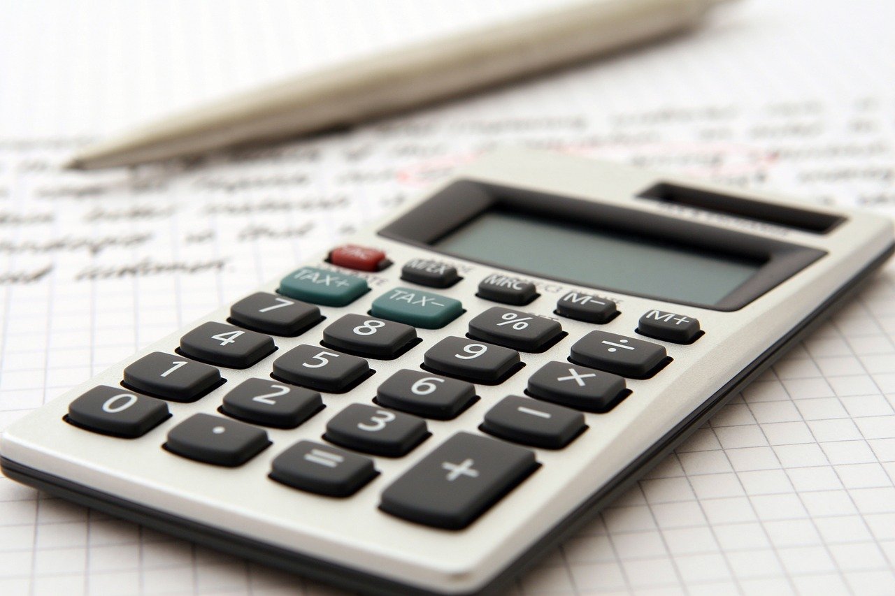 accounting calculator and pen on desk