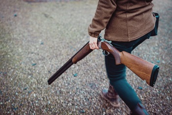 woman walking with firearm