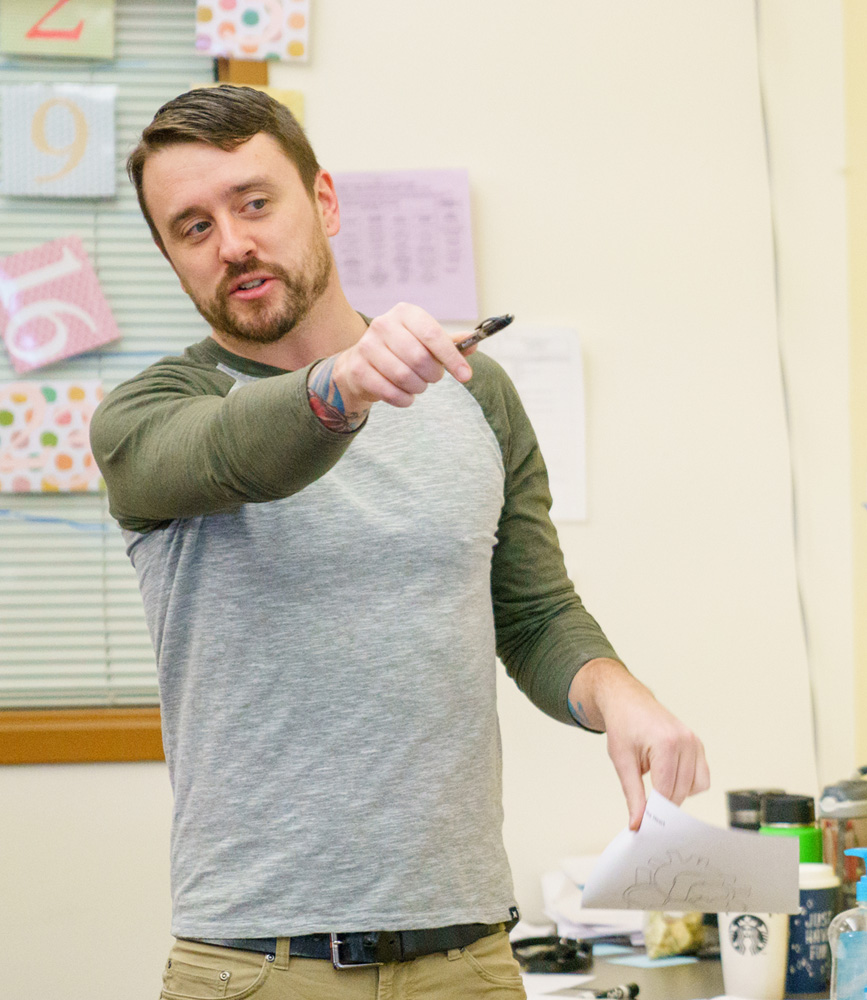 A special education teacher calls on a student using a pen and a cool unassuming posture