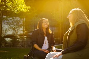 two female outside chatting