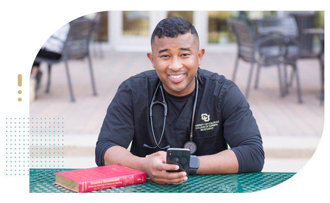 Male student nurse looking up from his phone on study break