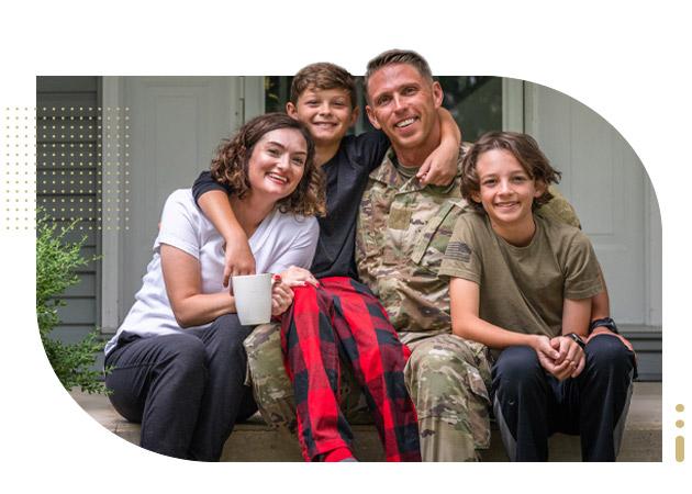 Male veteran sitting with his wife, and two sons on house porch