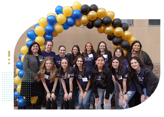 Group of college students celebrating with balloons