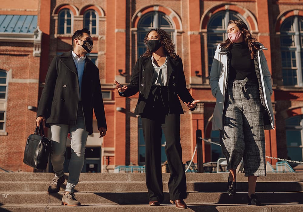 Three students in front of Tivoli