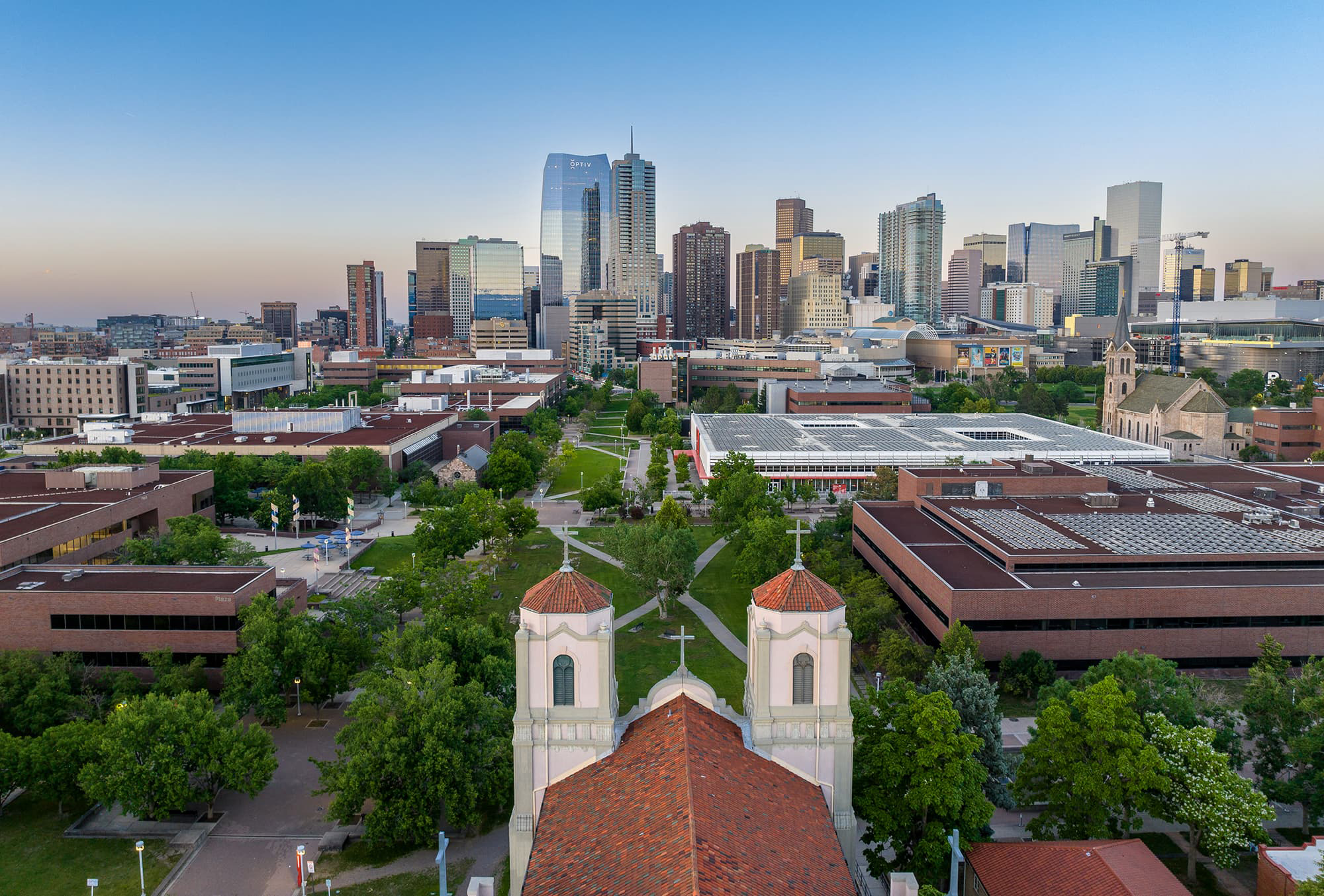 Aerial view of Auraria Campus and Denver cityscape, featuring St. Cajetans in the foreground.