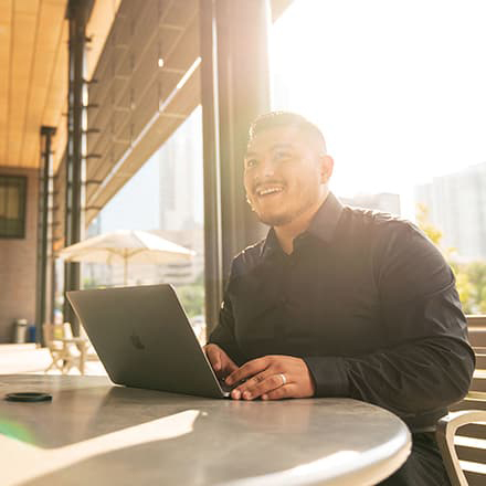 Student Sitting Outside With Laptop