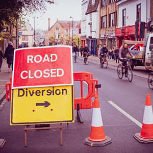 Road Closed sign with construction cones on a street