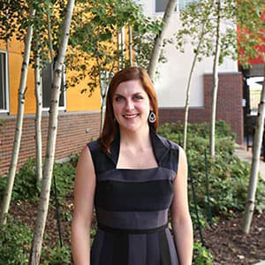 Megan Ray smiling outside Campus Village Apartments