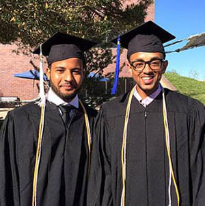 Robera Oljira and Abel Mebrahtu in commencement regalia