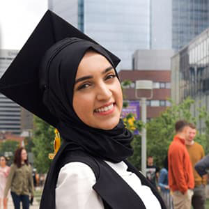 Saoussen Memmi with grad cap smiling