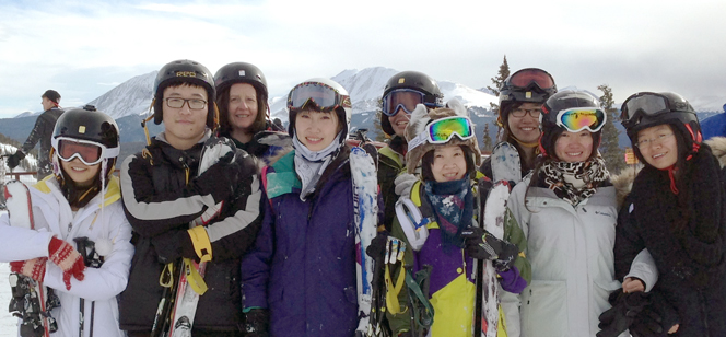 students posing at the top of a ski resort students posing at the top of a ski resort