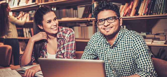 2 International Students Smiling in Library