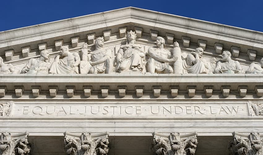 Closeup of the pediment of a building with the words 