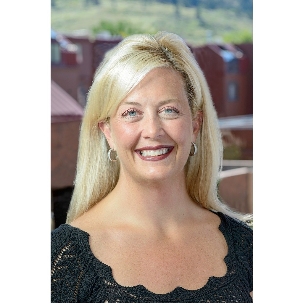 close-up headshot of Wendi Burkhardt from the shoulders up smiling in business casual attire