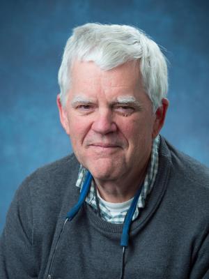 headshot of Clayton Lewis from the shoulders up in business casual sweater