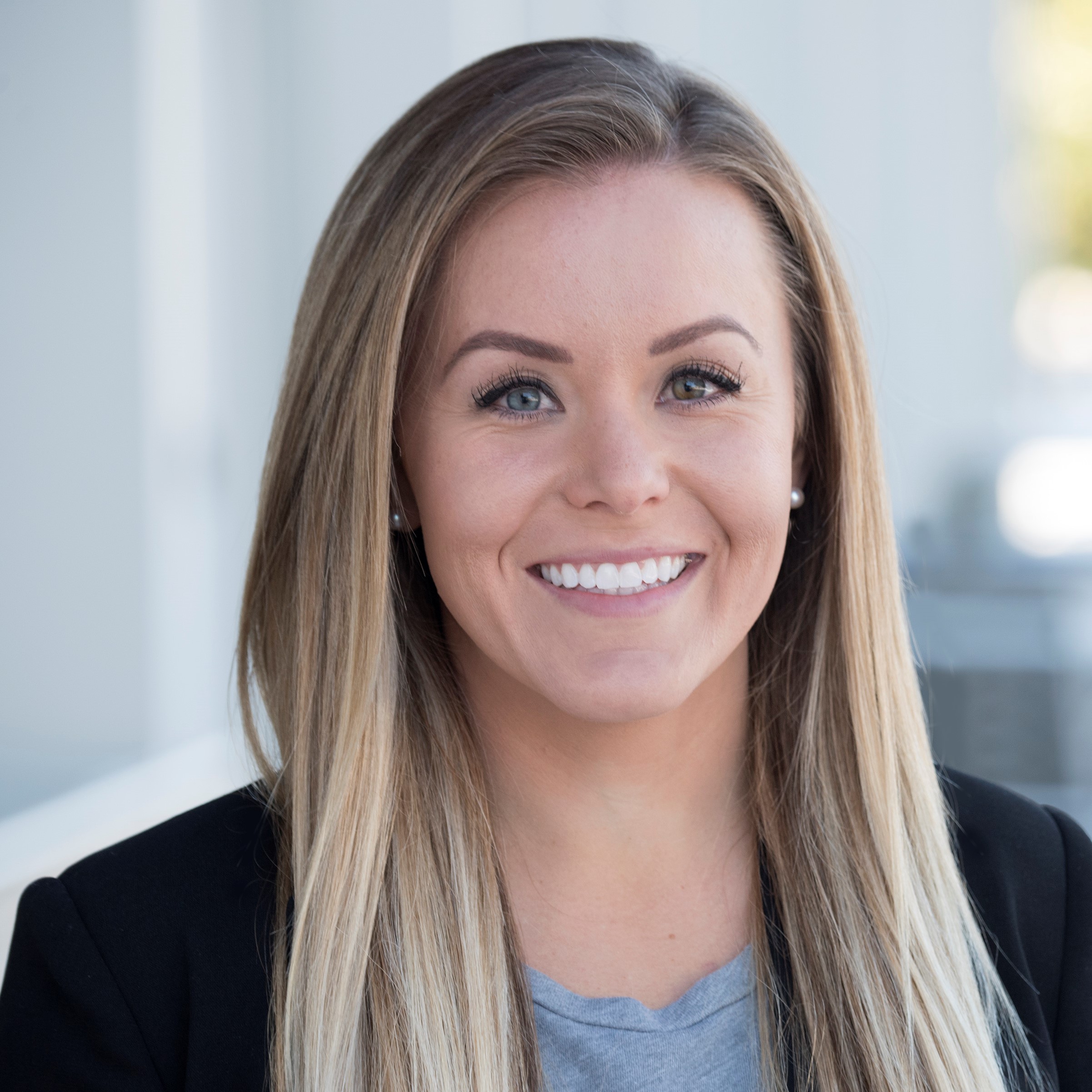 Headshot of Victoria Haggett smiling in business attire