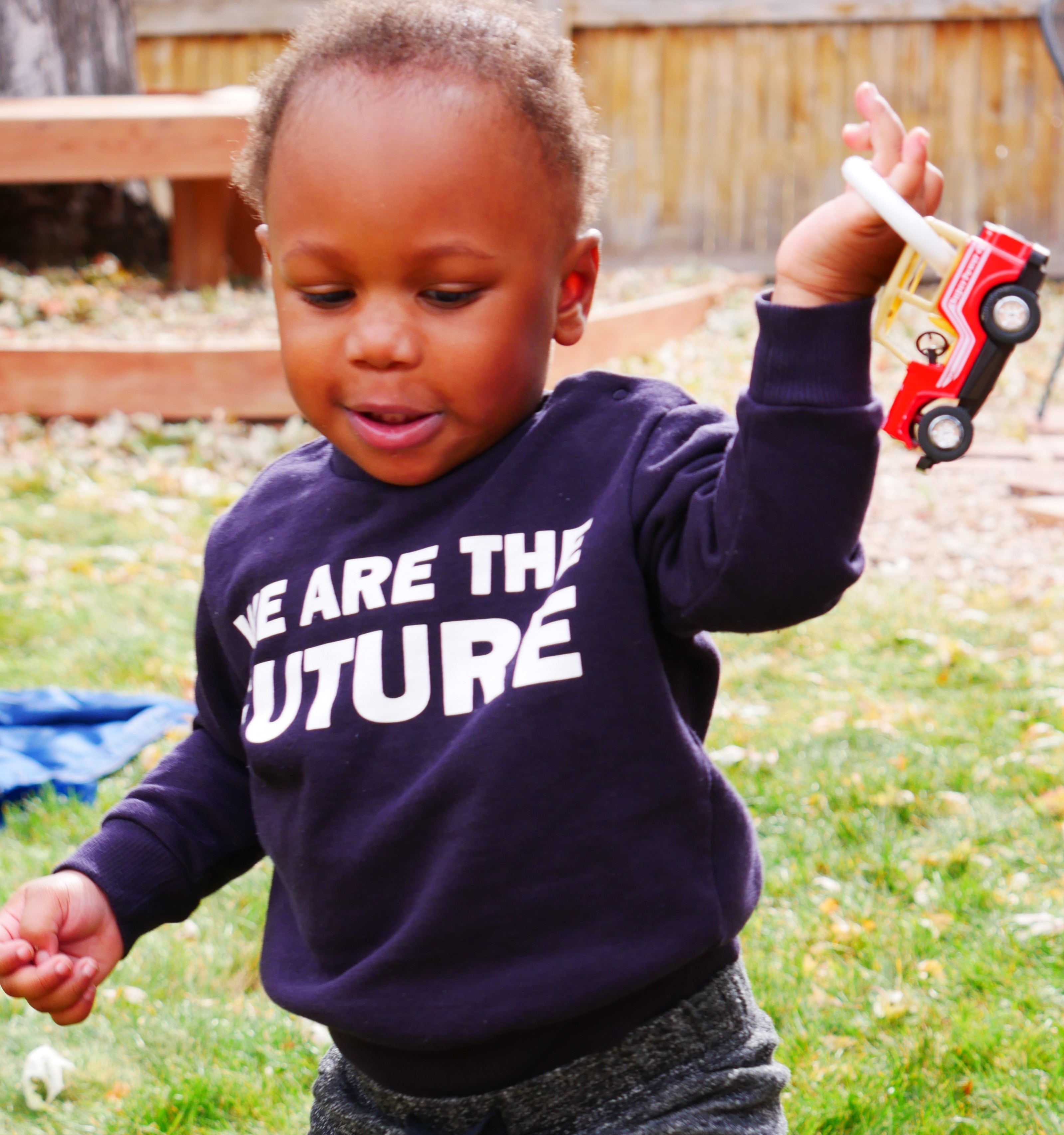 Little boy playing with a truck adapted with a shower ring