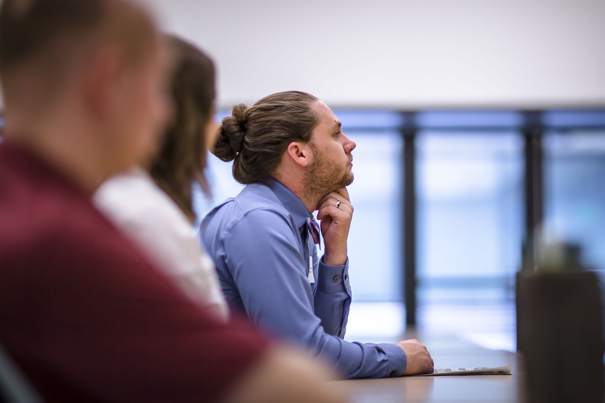 Adult learner focuses ahead while sitting at a desk.