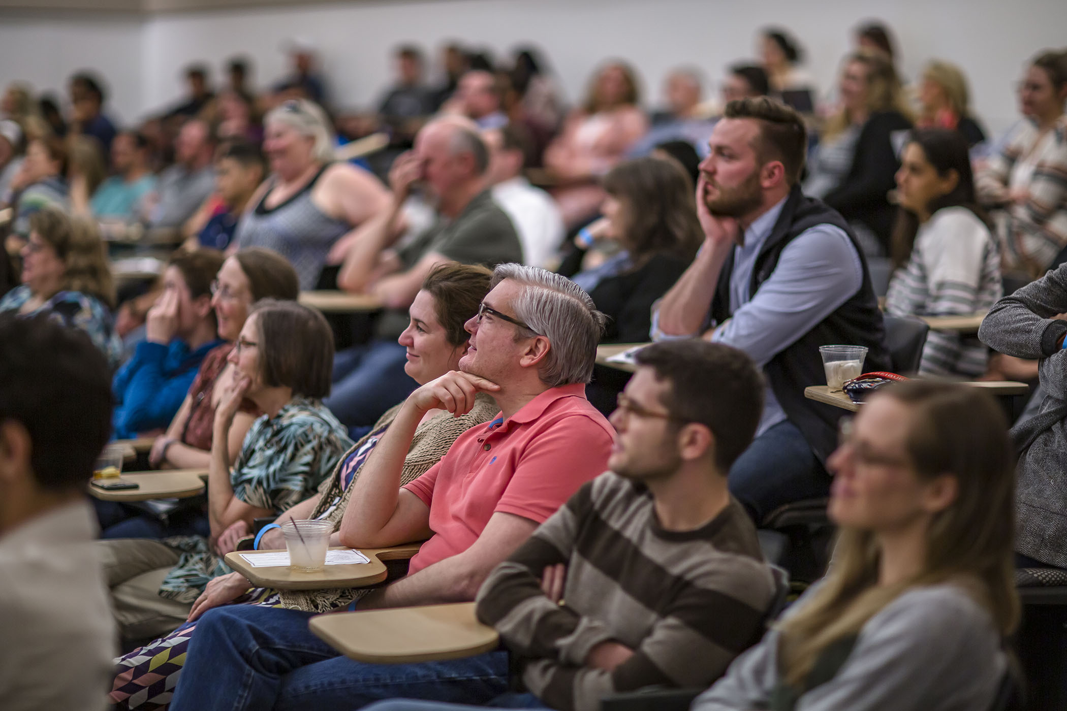 Adult learners paying attention in a lecture.