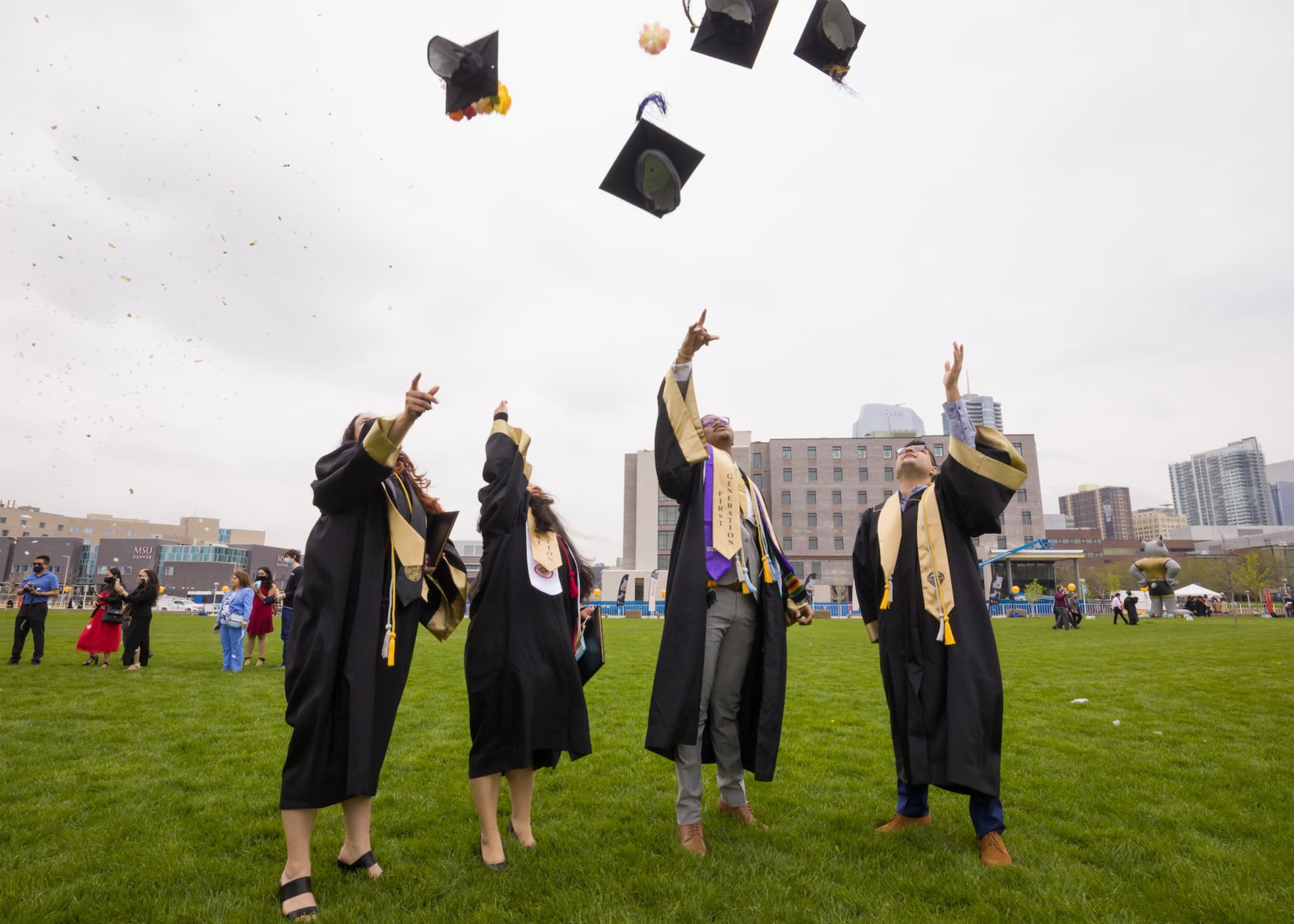 Graduates throw their caps