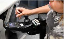 a woman drives her chair using a joystick