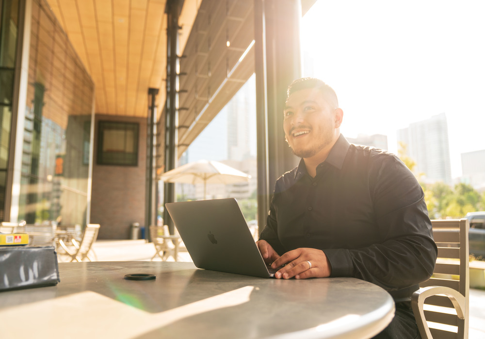 CU Denver student outside on laptop